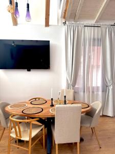 a dining room with a wooden table and chairs at Si apartments Free Parking in Sofia