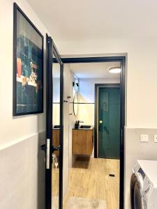 a bathroom with a door leading to a sink at Si apartments Free Parking in Sofia +66 photos