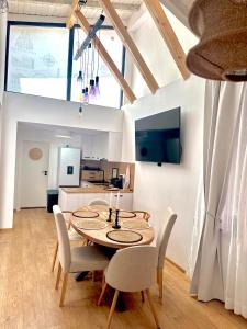 a kitchen and dining room with a table and chairs at Si apartments Free Parking in Sofia