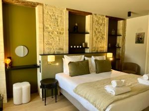a bedroom with a large bed with two towels on it at Domaine de Bayeux in Bayeux