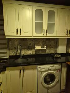 a kitchen with a sink and a washing machine at Ali Paşa Konağı Sarıyer in Sarıyer