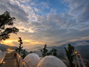 a view of the sunset from a observatory in the mountains at Glamp by Edge Resort Premium Luxury Domes with Mountain Views in Mussoorie +16 photos