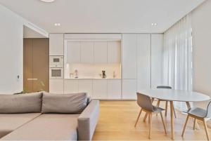 a living room with a couch and a table at Royal Hamilius Luxury 1 bed in Luxembourg