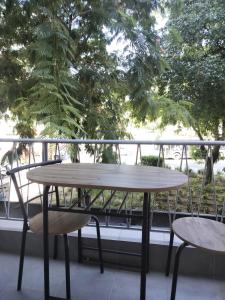 a table and two chairs on a balcony at Molly Downtown Thessaloniki in Thessaloniki