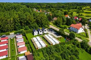 an aerial view of a village with houses and trees at Sosnowa Polana Rusinowo in Rusinowo