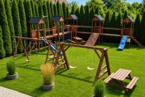a park with a playground with a slide and swings at Sosnowa Polana Rusinowo in Rusinowo
