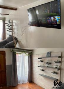 a living room with a television on the wall at Taltal - Casa Nordic in Taltal
