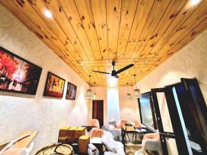 a room with tables and chairs and a ceiling at Glamp by Edge Resort Premium Luxury Domes with Mountain Views in Mussoorie