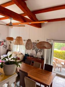 a dining room with a wooden table and chairs at Villa Regain Chambres et table d'hôtes in Gréolières