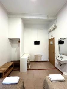 a bathroom with two beds and a sink in a room at Hostal Delfos in Barcelona