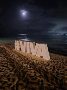a sign that says viva on a beach at night at Viva paradise in Punta Cana