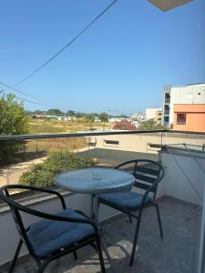 a table and two chairs on a balcony at Vesa&Veton in Donji Štoj