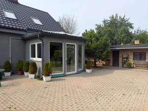 a house with a conservatory with potted plants at Dorupes House in Liepāja