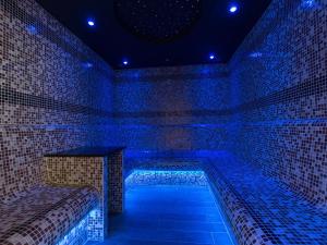 a room with blue lights on a brick wall at Una Argentum 62 in Carbis Bay +19 photos