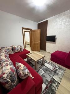 a living room with a red couch and a table at Vesa&Veton in Donji Štoj