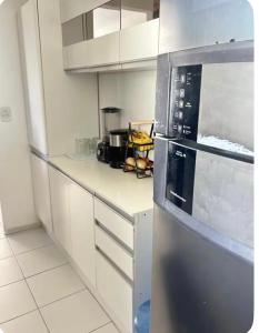 a kitchen with a stainless steel refrigerator at Apto no Janga in Paulista