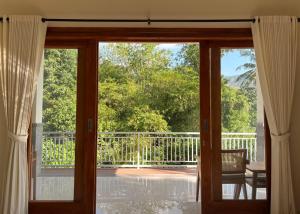 a door to a balcony with a view of a patio at Kayana Amed in Amed +6 photos