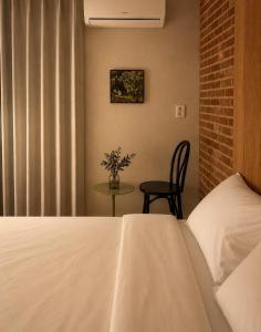 a bedroom with a bed and a table with a chair at Stay PAUSE in Bucheon +7 photos