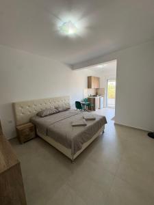 a bedroom with a large bed and a table at Vesa&Veton in Donji Štoj