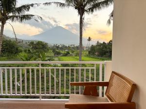 a room with a balcony with a view of a mountain at Kayana Amed in Amed