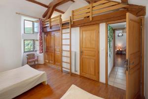 a bedroom with a bunk bed and a door at Chambres Et Table D'hôtes De Vernet in Saint-Germain-de-Calberte