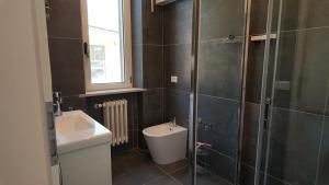 a bathroom with a toilet and a sink and a shower at Villa Mario in Senigallia