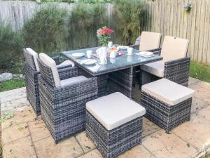 a wicker table and chairs on a patio at Sea Thrift in Port Isaac +6 photos