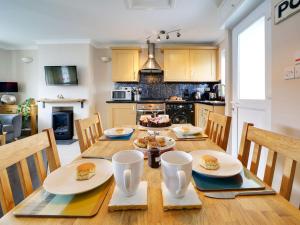 a kitchen with a wooden table with food on it at Sea Thrift in Port Isaac