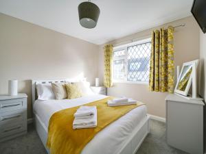 a bedroom with a bed with towels on it at Sea Thrift in Port Isaac