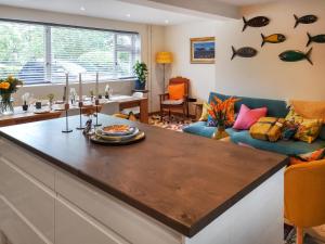 a kitchen with a large island in a living room at Alscott Cottage in Bishops Tawton