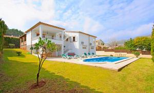 a house with a swimming pool in a yard at Villa Can Tomas in Port de Pollensa