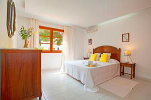 a bedroom with a bed and a window at Villa Can Tomas in Port de Pollensa