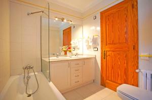 a bathroom with a tub and a sink and a shower at Villa Can Tomas in Port de Pollensa +24 photos