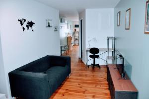 a living room with a couch and a table at Dormir près de Brioude - studio 'esprit vacances' in Fontannes
