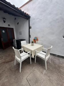 a white table and chairs on a patio at Casa Tradicional Canaria - Chico in Garachico