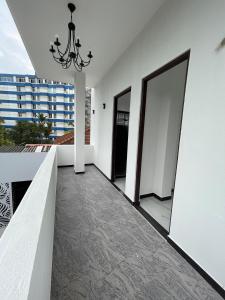 a hallway with a door leading to a balcony at Rest Inn Tourist Hotel in Gampaha