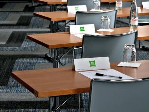 a classroom with tables and chairs with cards on them at ibis Styles Avignon Sud in Avignon