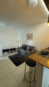 a living room with a couch and a table at Apartamento Studio 003 in Caruaru