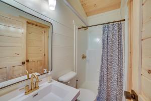 a bathroom with a sink and a toilet and a mirror at Off-Grid & Solar-Powered! Mtn-View Omaha Cabin in Omaha +14 photos