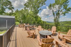 a wooden deck with tables and chairs on it at Off-Grid & Solar-Powered! Mtn-View Omaha Cabin in Omaha