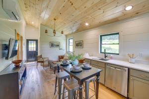 a kitchen and living room with a table and chairs at Off-Grid & Solar-Powered! Mtn-View Omaha Cabin in Omaha