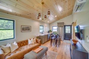 a living room with a couch and a kitchen at Off-Grid & Solar-Powered! Mtn-View Omaha Cabin in Omaha