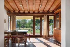a dining room with a table and chairs at Villa Il Rossignolo con Piscina in Grassina