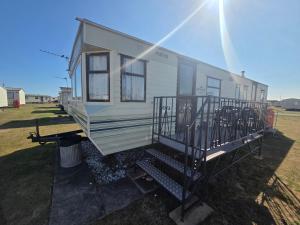 a mobile home is parked in a field at Beckys Holiday Van in Ingoldmells