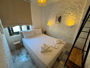 a bedroom with a bed with two white boxes on it at Afet inn in Çeşme