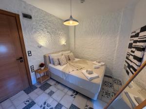 a small bedroom with a bed in a room at Afet inn in Çeşme +2 photos
