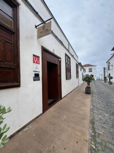 a building with a door and a sign on it at Casa Tradicional Canaria in Garachico