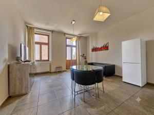 a living room with a table and a refrigerator at Teplice Apartments U Schodů in Teplice