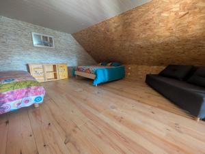 a room with two beds and a couch in it at Le relais de la mine in Champagnac