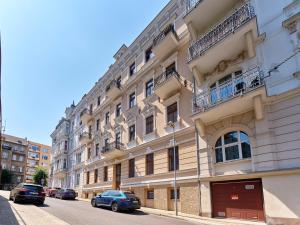 a large building with cars parked on a street at Teplice Apartments U Schodů in Teplice